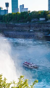 A tour boat cruises near the magnificent Niagara Falls, capturing the essence of adventure and natural beauty.