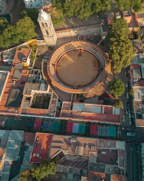 Free A breathtaking aerial view of the bullring in Tlaxcala, Mexico, surrounded by vibrant urban landscape. Stock Photo