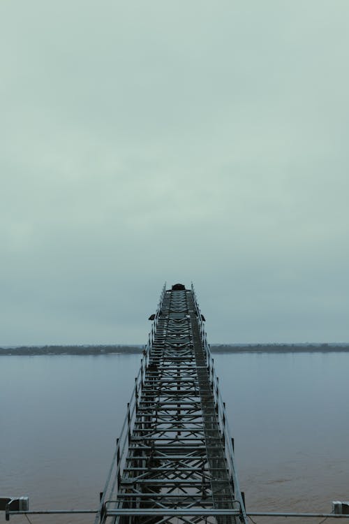 Metal Construction over Lake on Cloudy Day