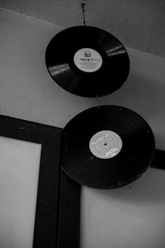Artistic shot of vintage vinyl records hanging from the ceiling, capturing a retro vibe.