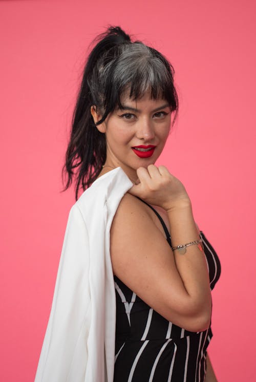 Studio Shot of a Young Woman with Dyed Hair and Wearing Red Lipstick