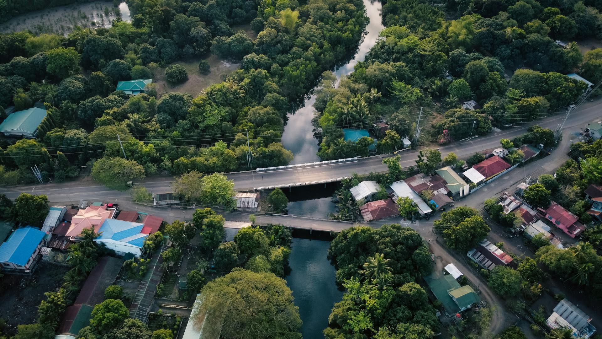 Scenic aerial view of Santa Cruz village with lush greenery and river in Central Luzon, Philippines.