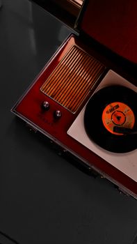Retro gramophone with vinyl record player showing an LP from above.
