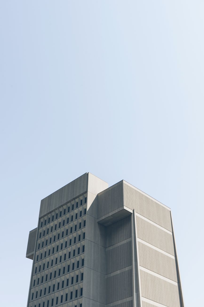 Tall, modern building against a clear blue sky in downtown London, Ontario.