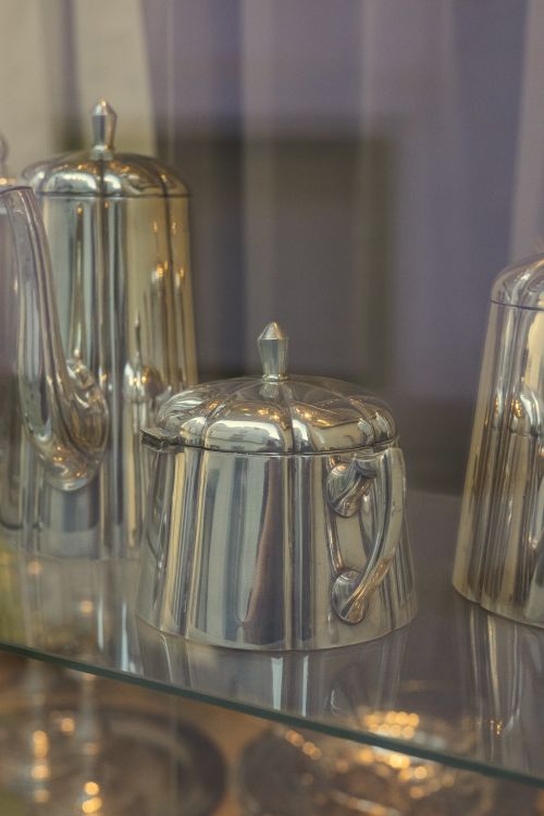 Free Close-up of polished silverware on a glass shelf, showcasing elegance and style in dining. Stock Photo