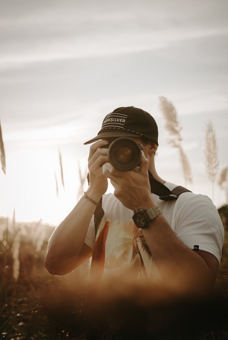 Man Taking Picture With Camera In Nature On Sunset