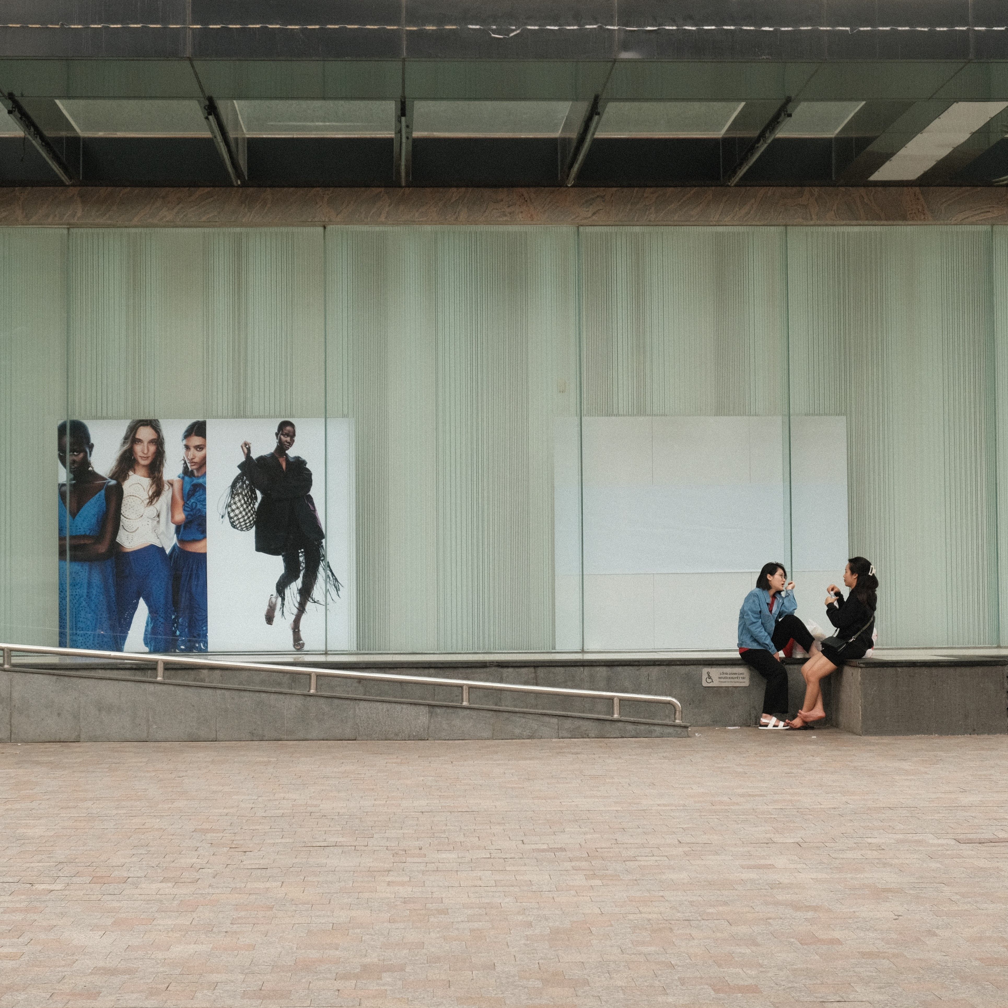 Women Sitting on Wall and Talking