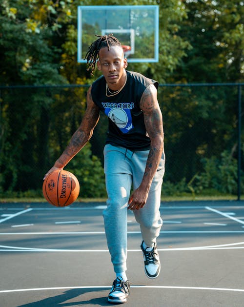 Man with Tattoos Playing Basketball