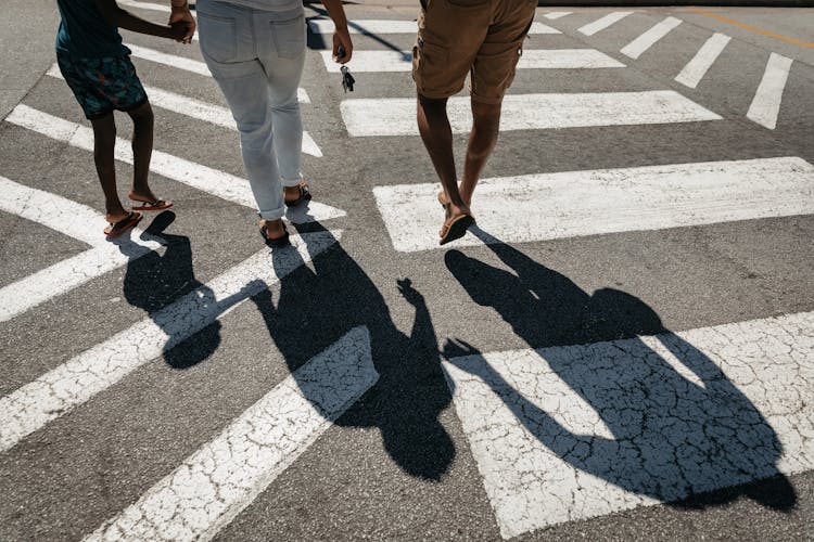 Parents With Kid At Zebra Crossing