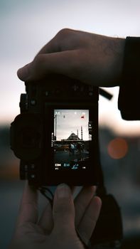 Digital camera display shows a majestic mosque during sunset, emphasizing iconic architecture.