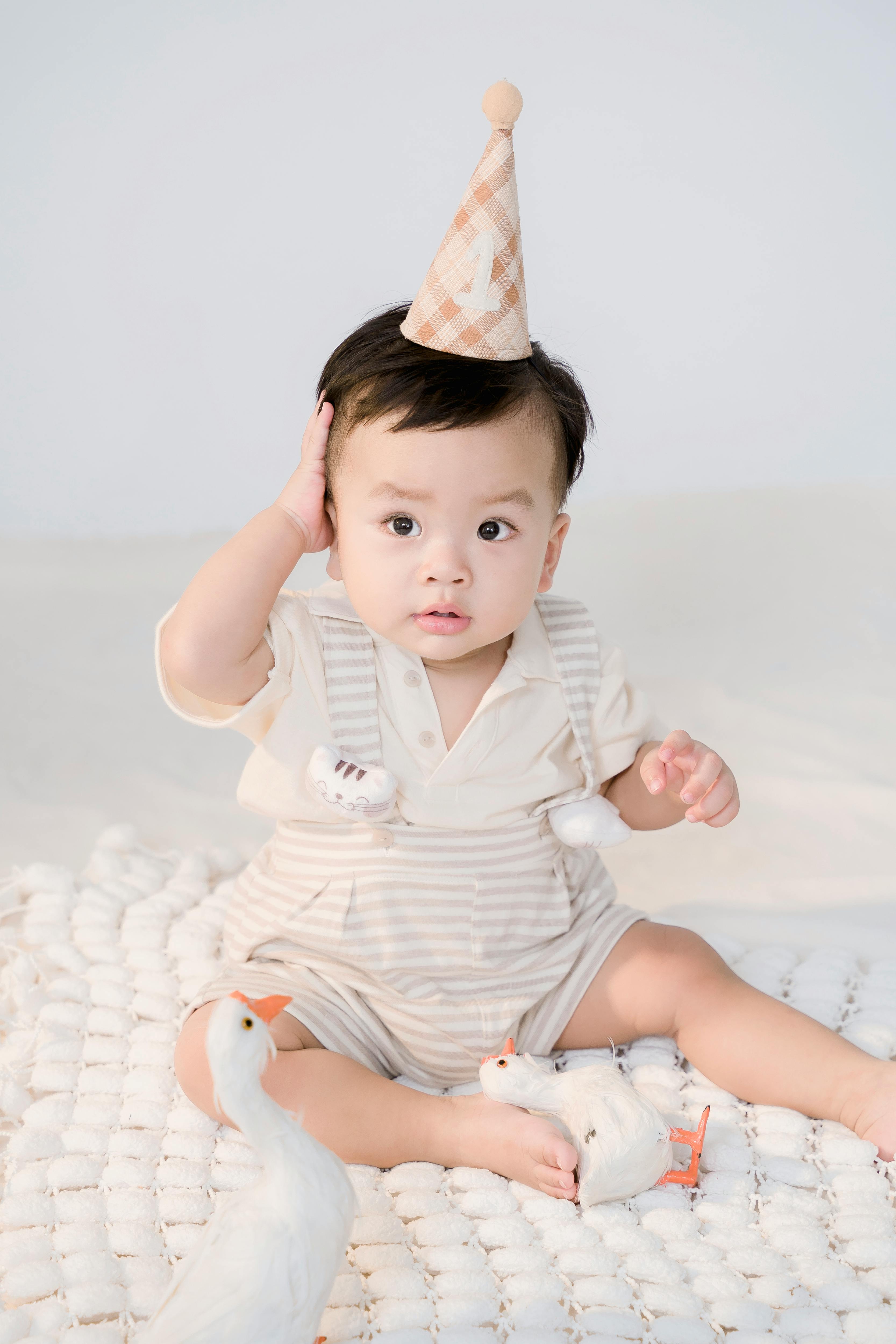 little boy in a birthday hat