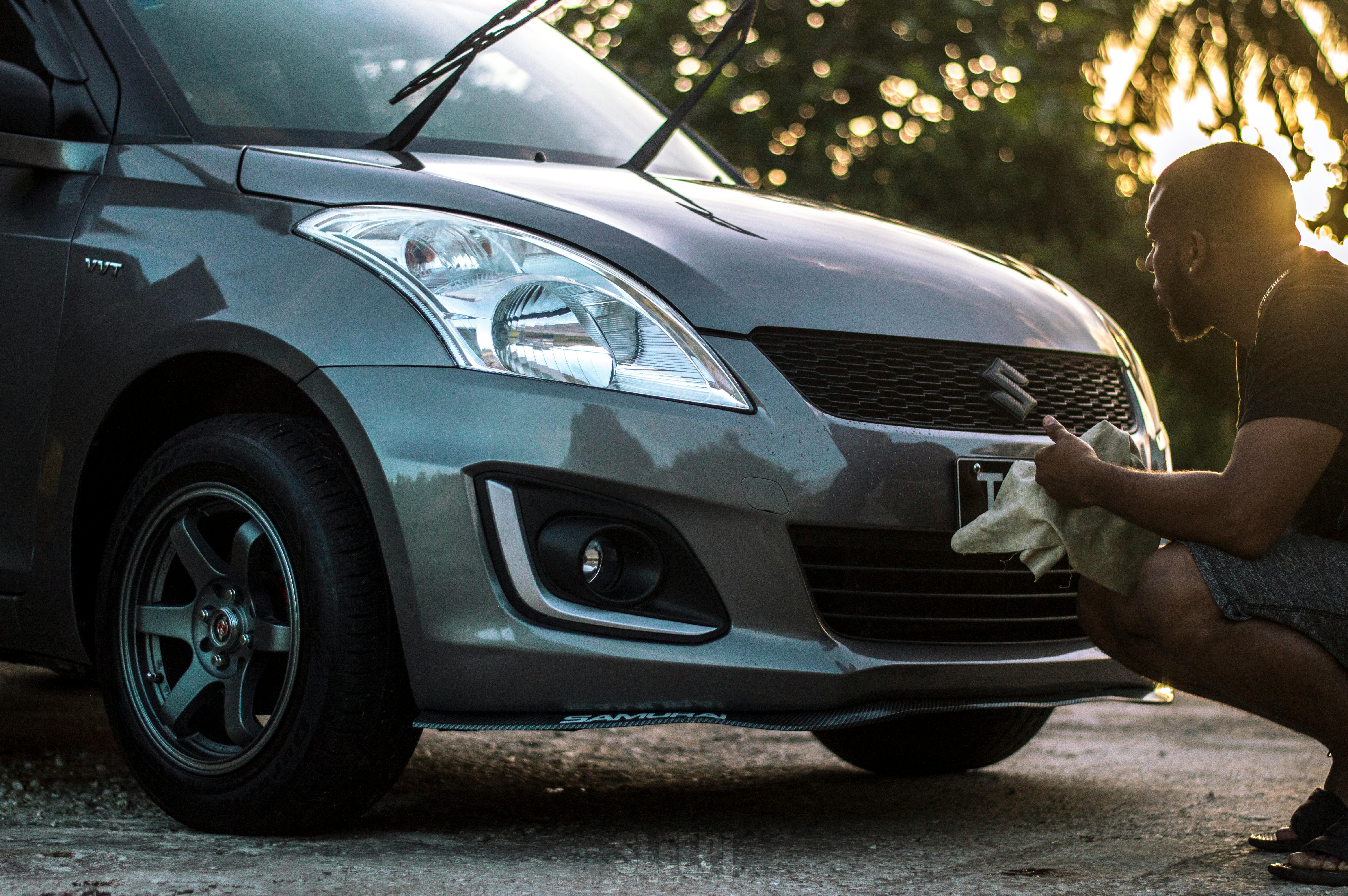 Photo of Man Cleaning His Car