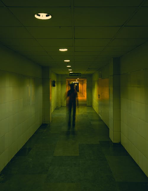 Person Walking in an Empty Corridor 
