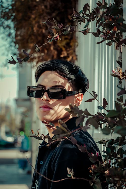 Young Man in Trendy Sunglasses Standing Outside 