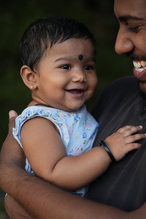 Happy Father Holding Baby Daughter