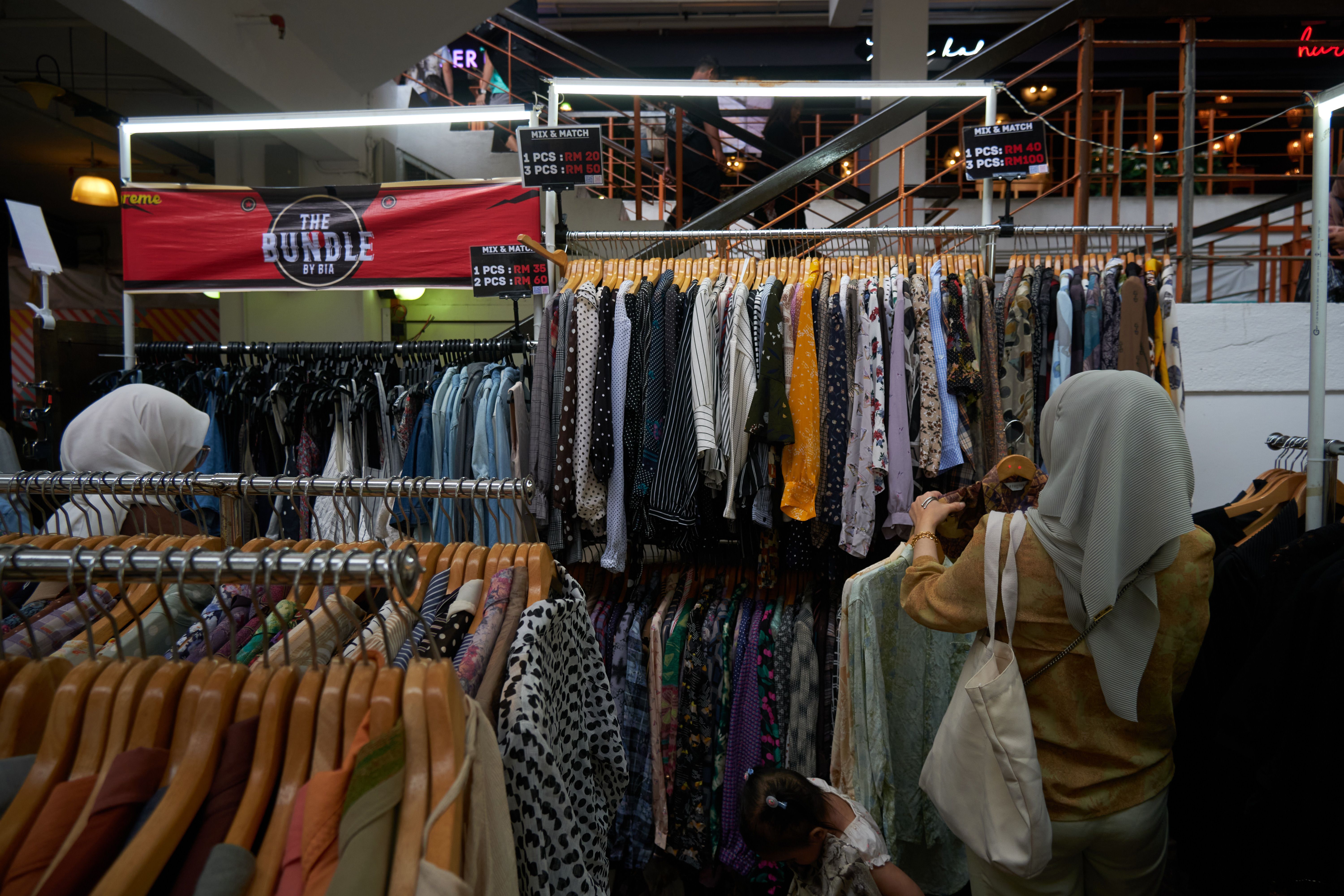 Shoppers browse clothing racks at a TJX off-price store, where comparable sales rose 4% in Q2.