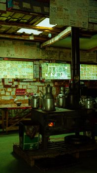 A cozy interior featuring a vintage stove and kettles surrounded by pinned notes and messages.