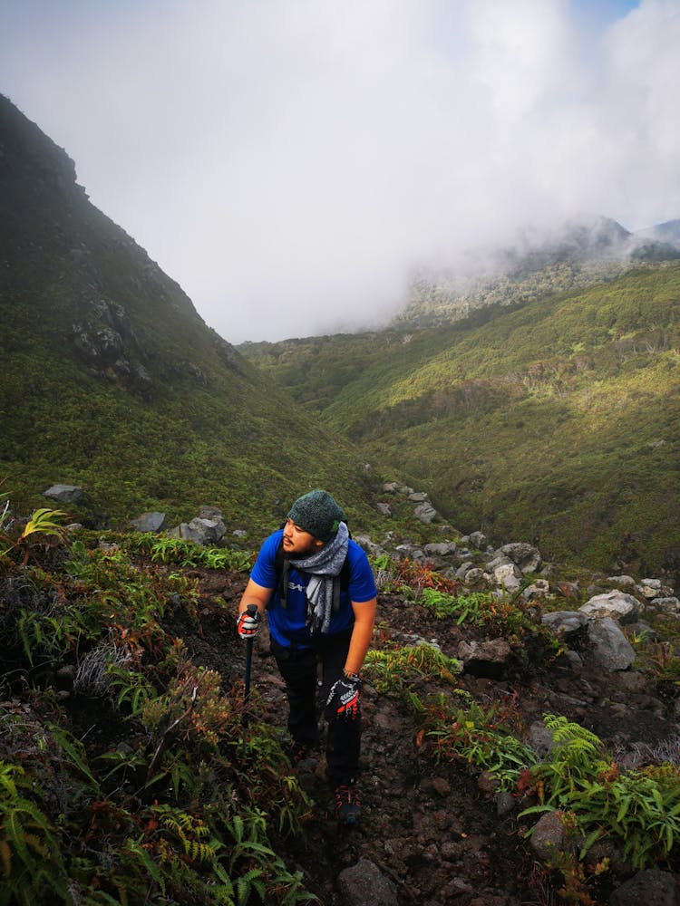 Man Hiking In Green Mountains