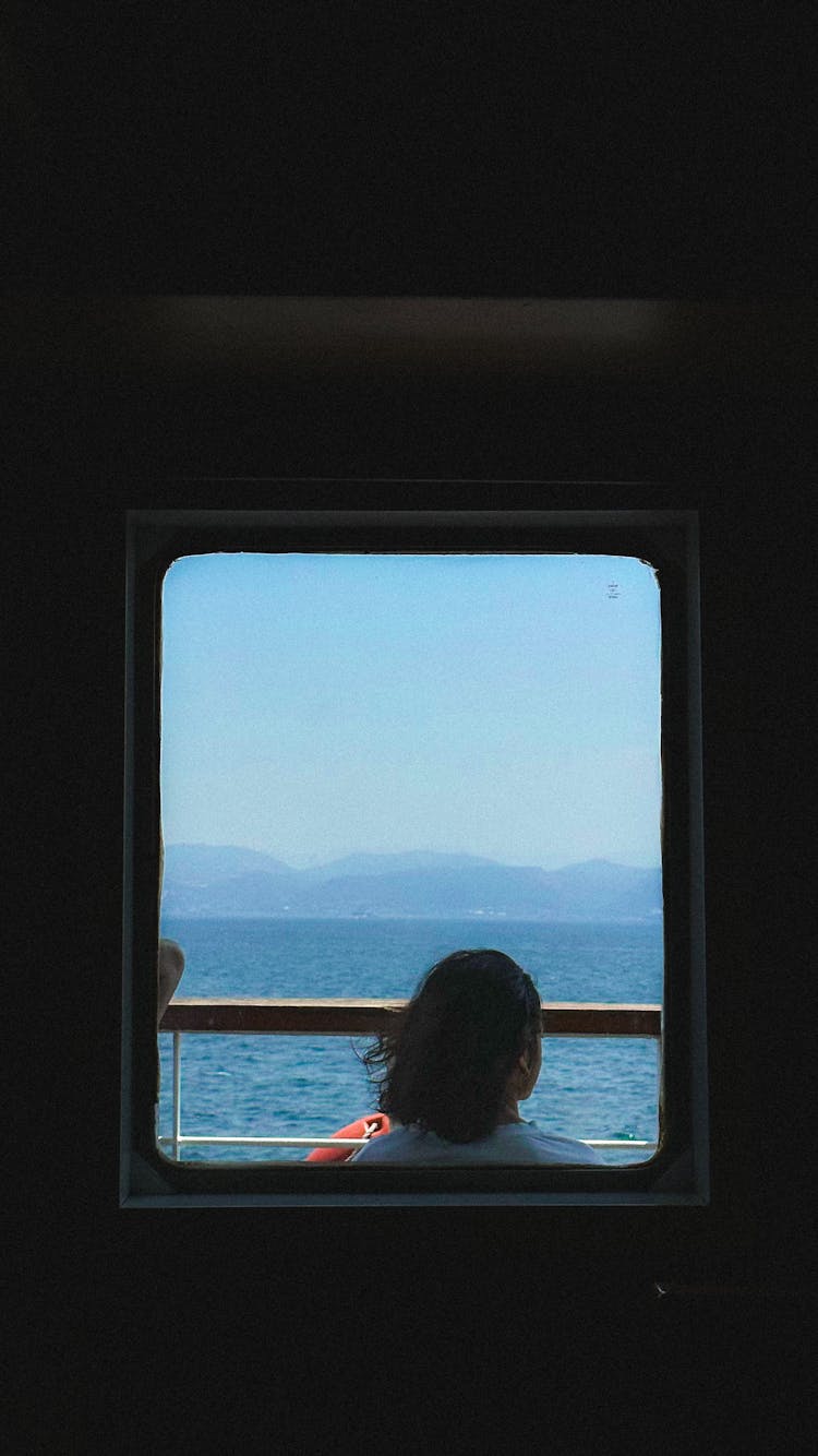 Woman Behind Window Of Sailing Vessel