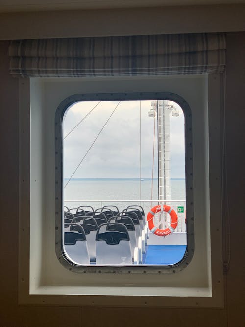 Empty Ferry Seats seen through a Rectangular Window