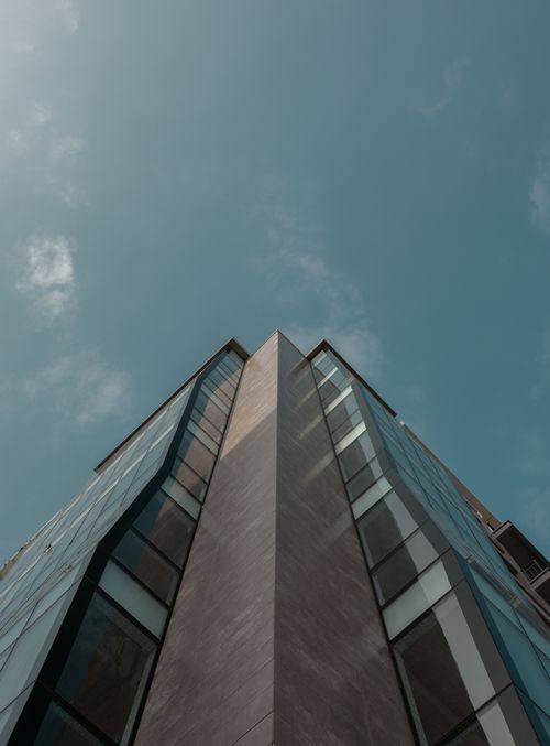 Free Low angle view of a modern building corner against a clear blue sky in Baku, Azerbaijan. Stock Photo