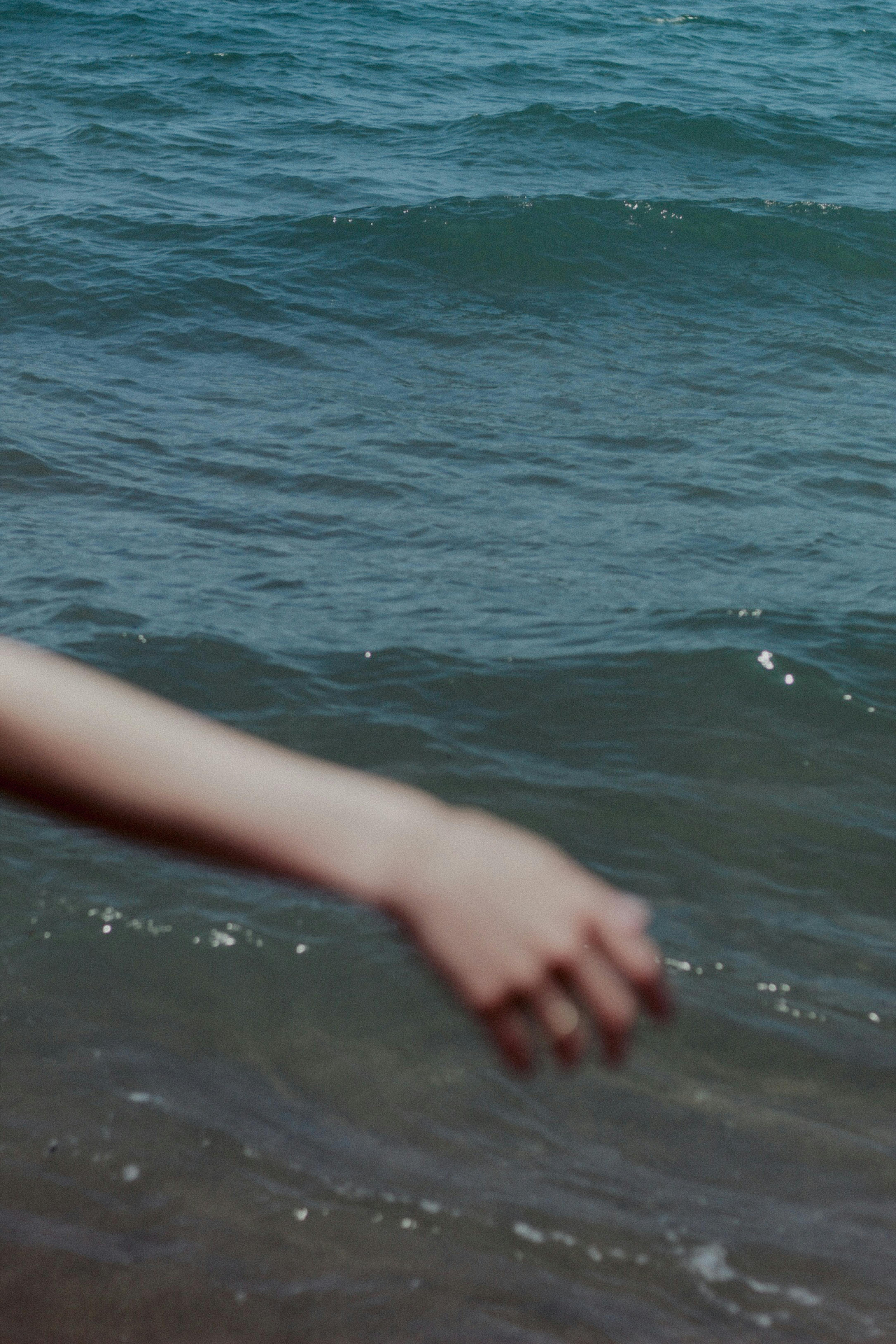 defocused picture of an arm on the background of the sea