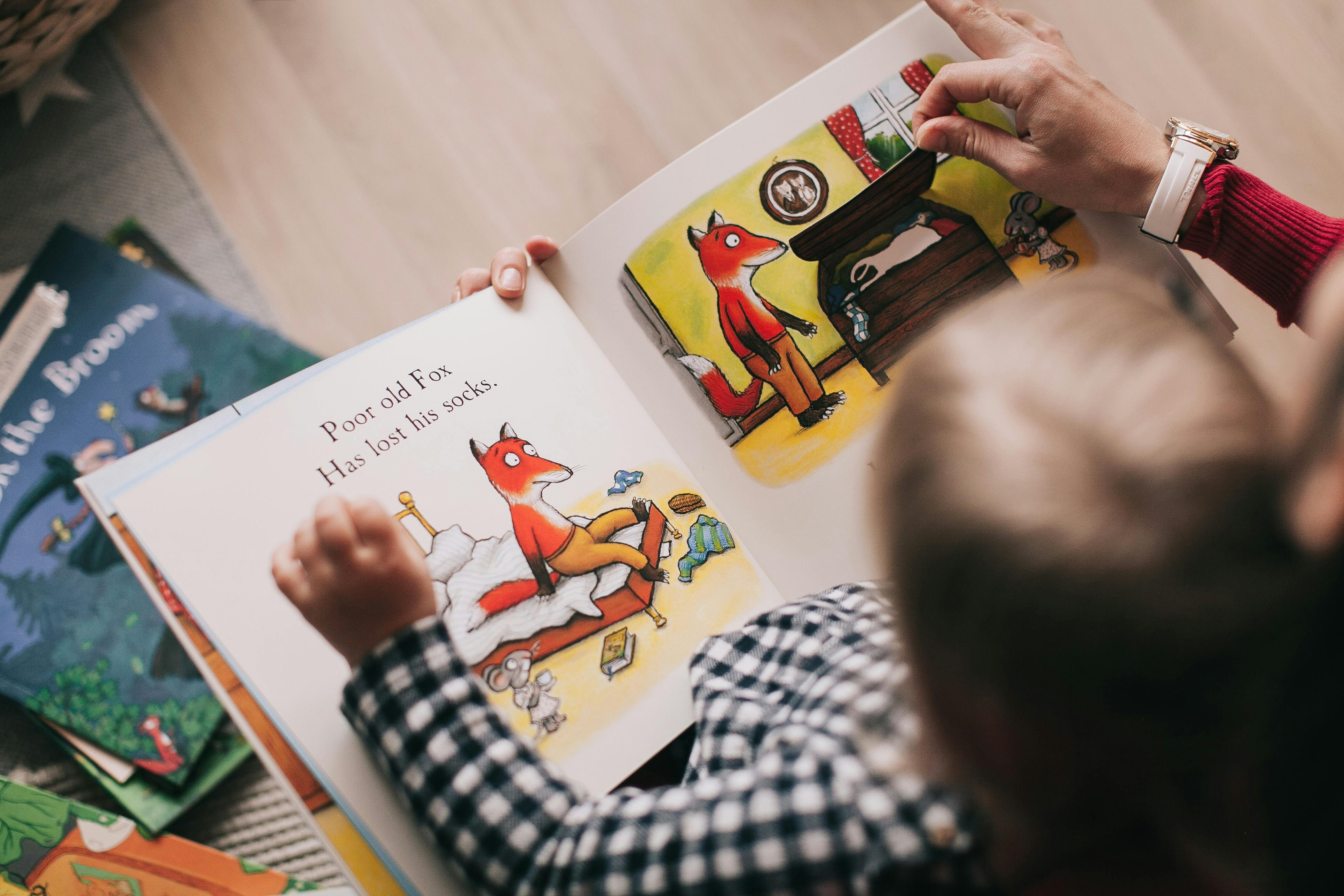 Children reading a book together