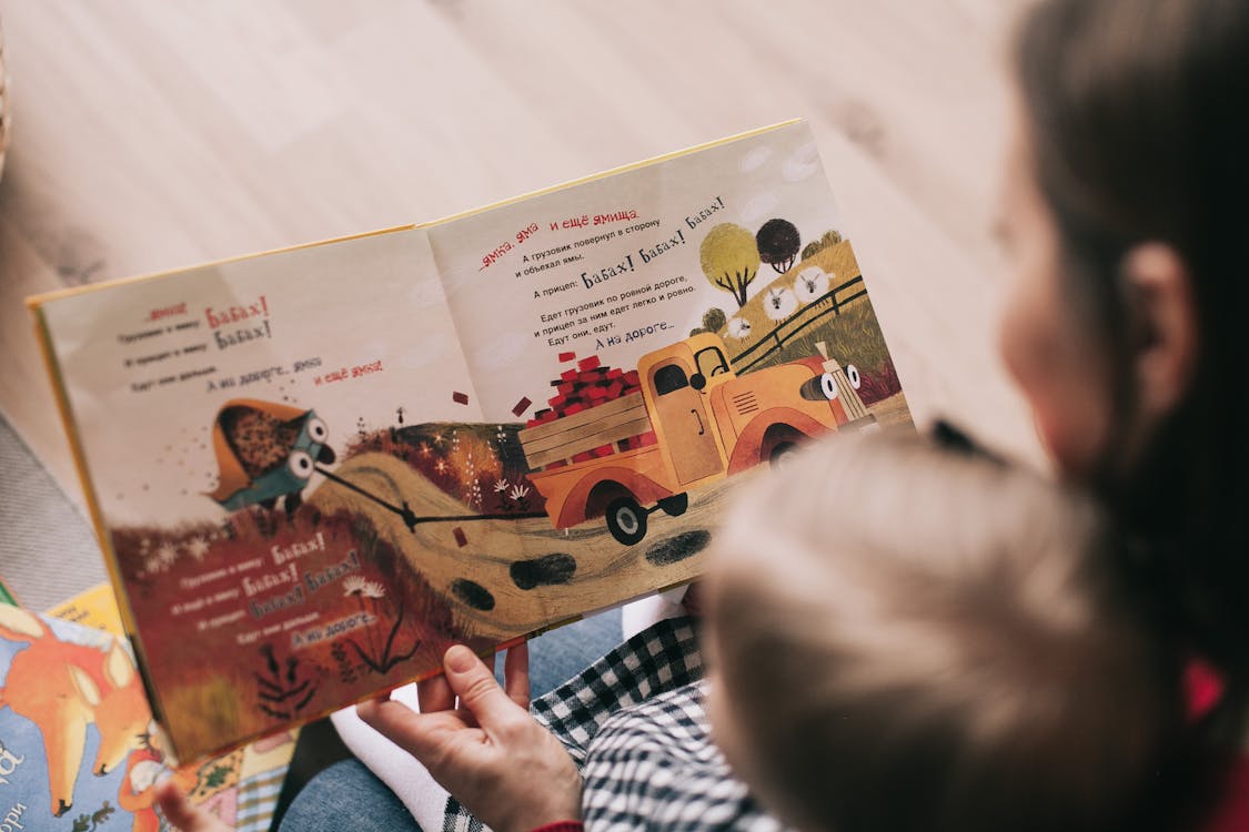 Free Woman Reading Book to Toddler Stock Photo