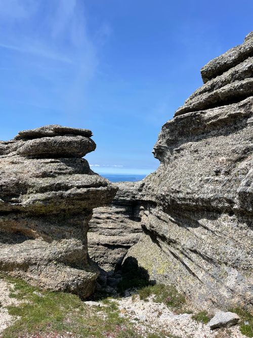 Free Captivating coastal rock formations with a scenic sea view under a bright blue sky. Stock Photo