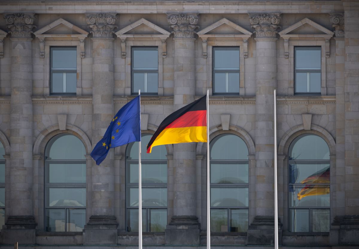 German and European Union flags flying together in front of a government building in Berlin