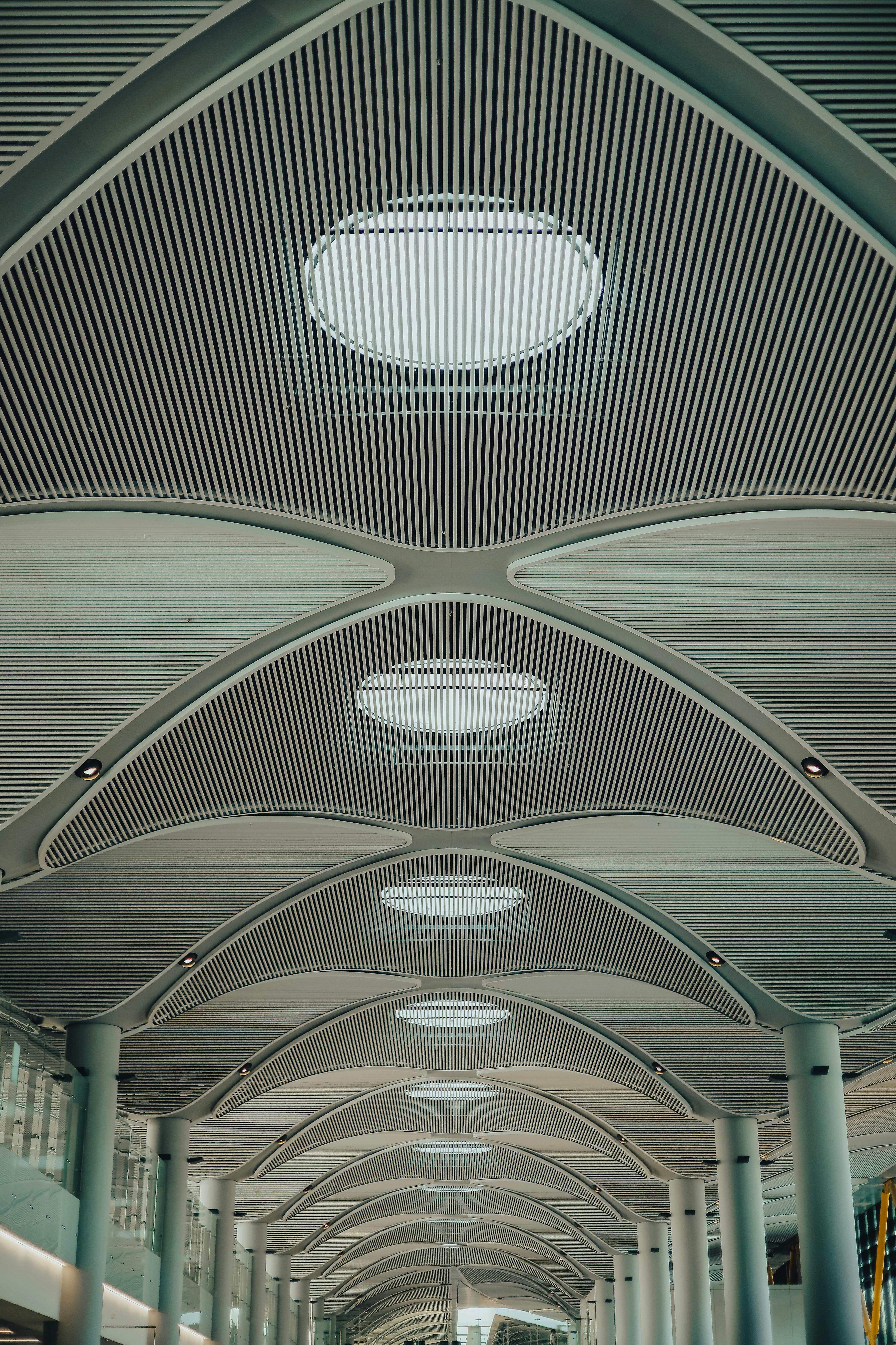 Modern and futuristic ceiling design of Istanbul airport terminal, showcasing architectural innovation.