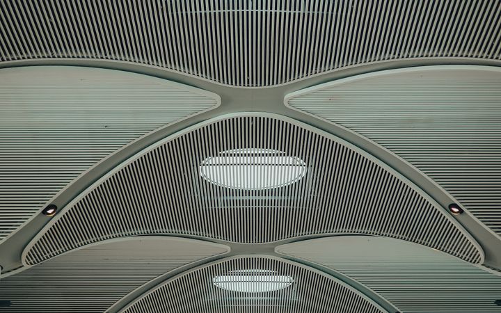 Modern and futuristic ceiling design of Istanbul airport terminal, showcasing architectural innovation.