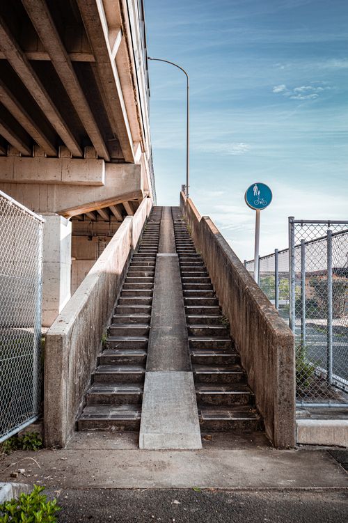 Free Concrete stairway with bicycle path under a bridge in Toyohashi, Japan. Stock Photo