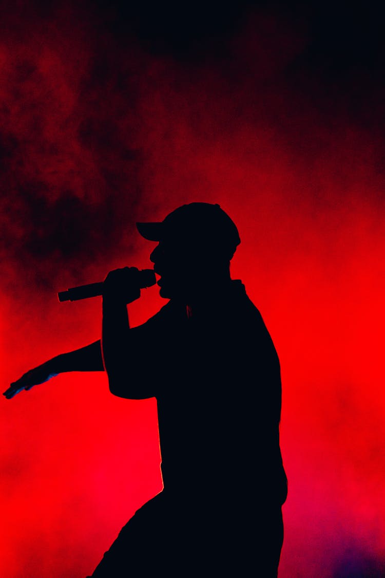 Silhouette Of A Singer Singing At A Concert 