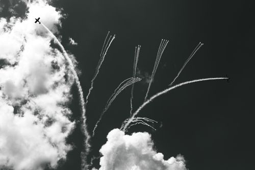 Free Black and white photo of airplanes creating contrails in the Abruzzo sky. Stock Photo
