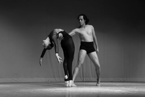 Free Black and white photo of a male and female ballet dancers performing on stage. Stock Photo