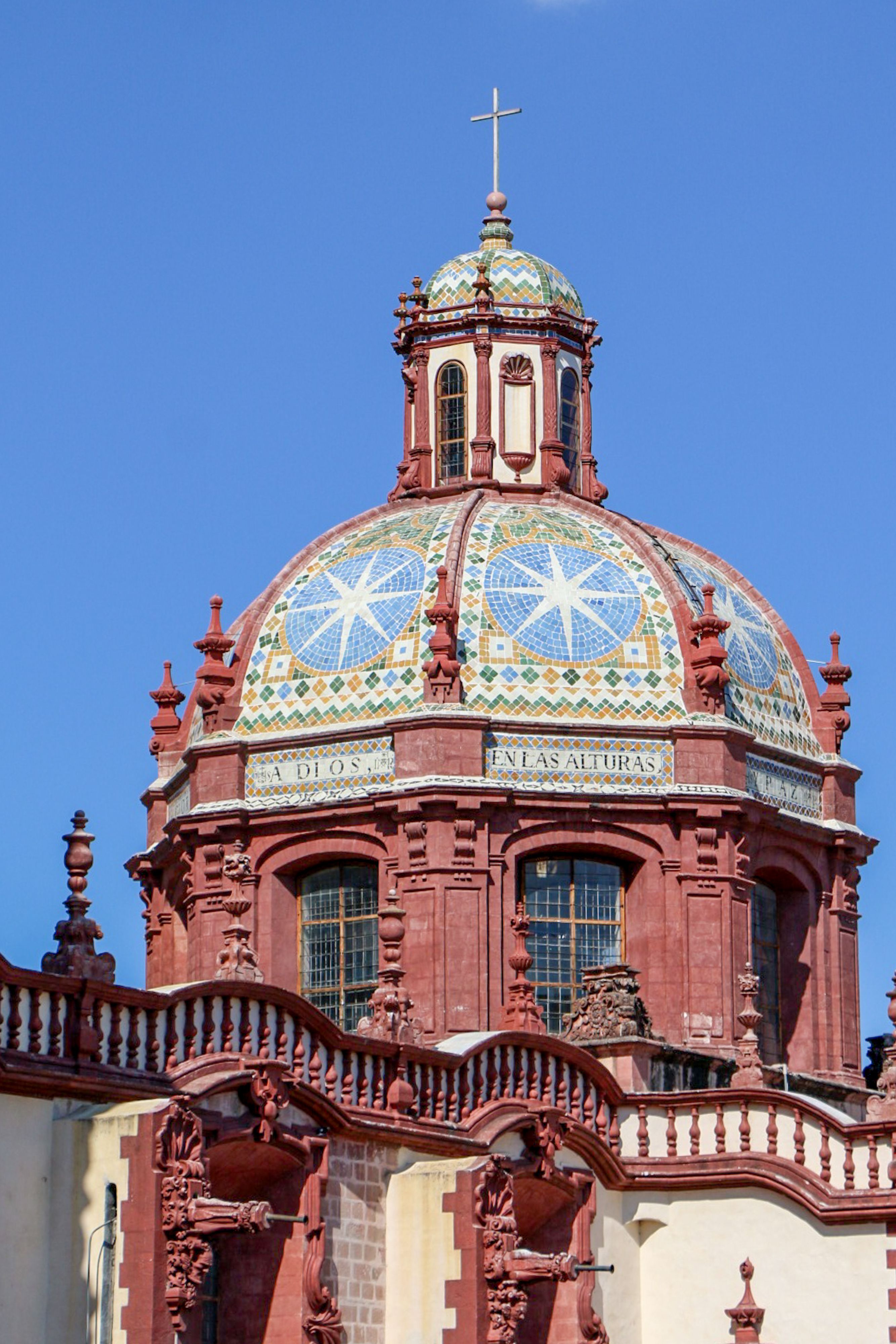 Detailed view of the colorful dome of Santa Prisca Church in Taxco, Mexico showcasing baroque architecture.