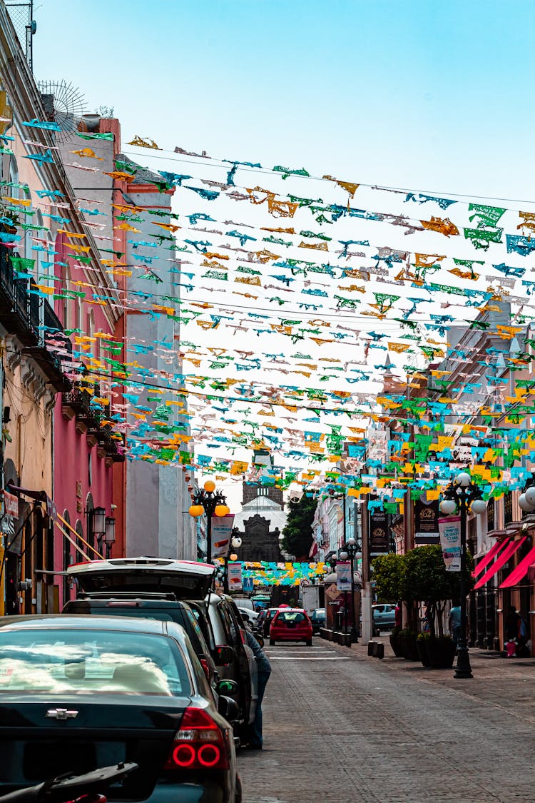 Colorful Cloths Over Cars Parked On Street