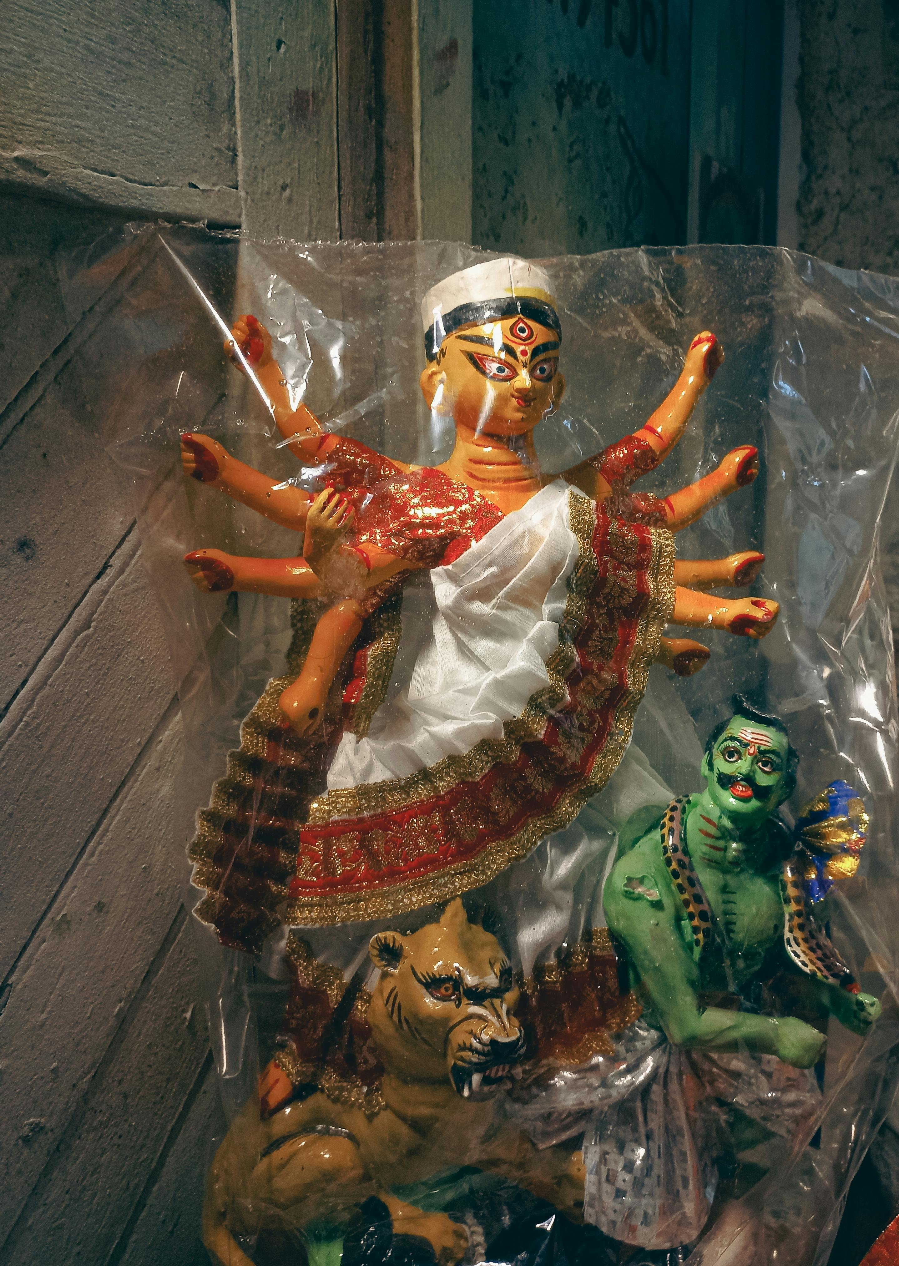 Colorful Statues of Deities Covered with Plastic Foil · Free Stock Photo