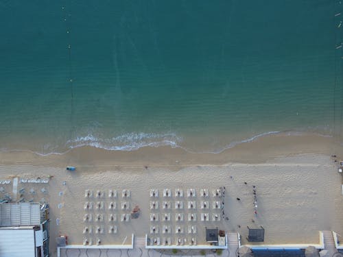 Top View of Empty Sun Loungers on a Beach 
