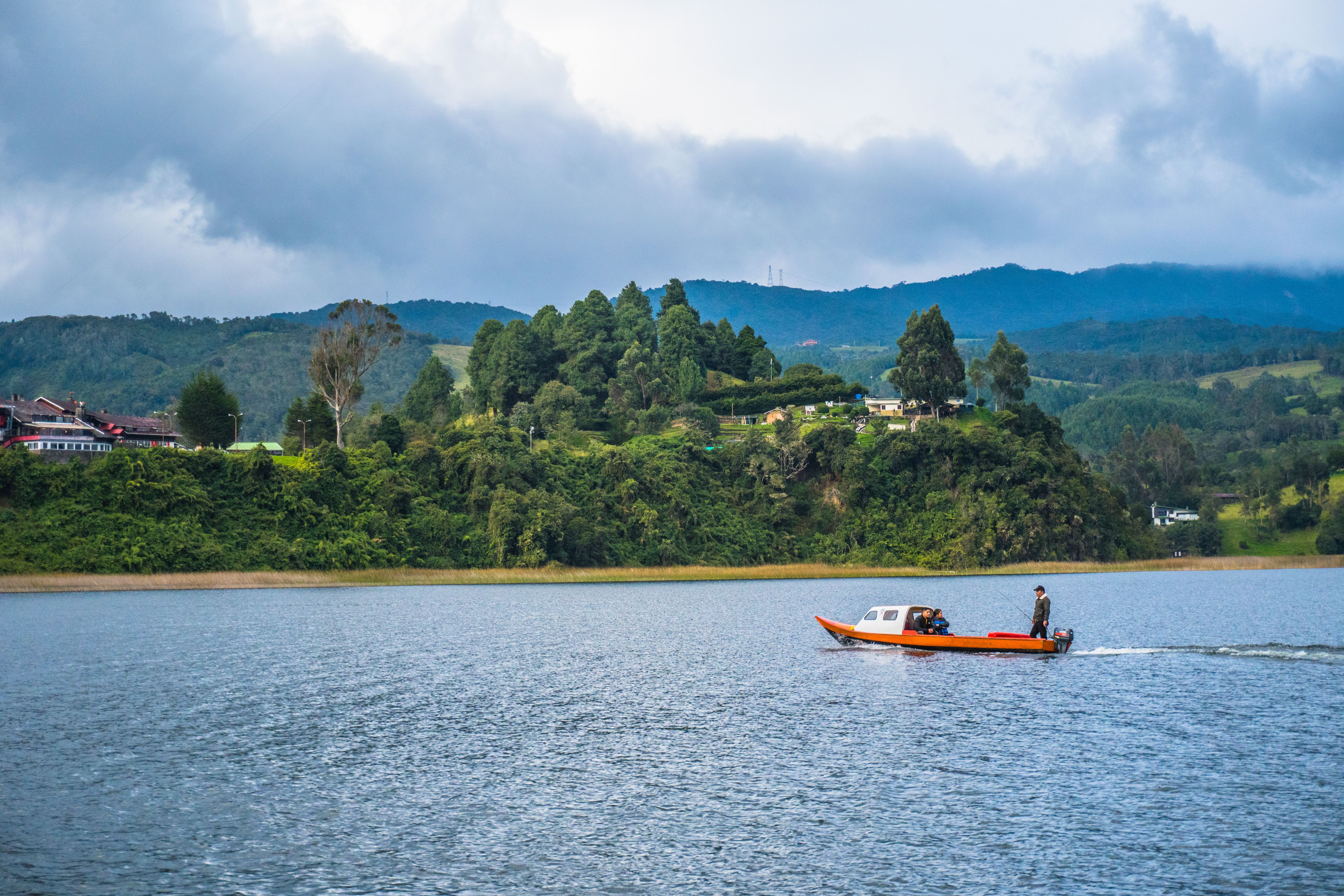 Picturesque scene of La Cocha Lake in Nariño, Colombia with a boat on a cloudy day.