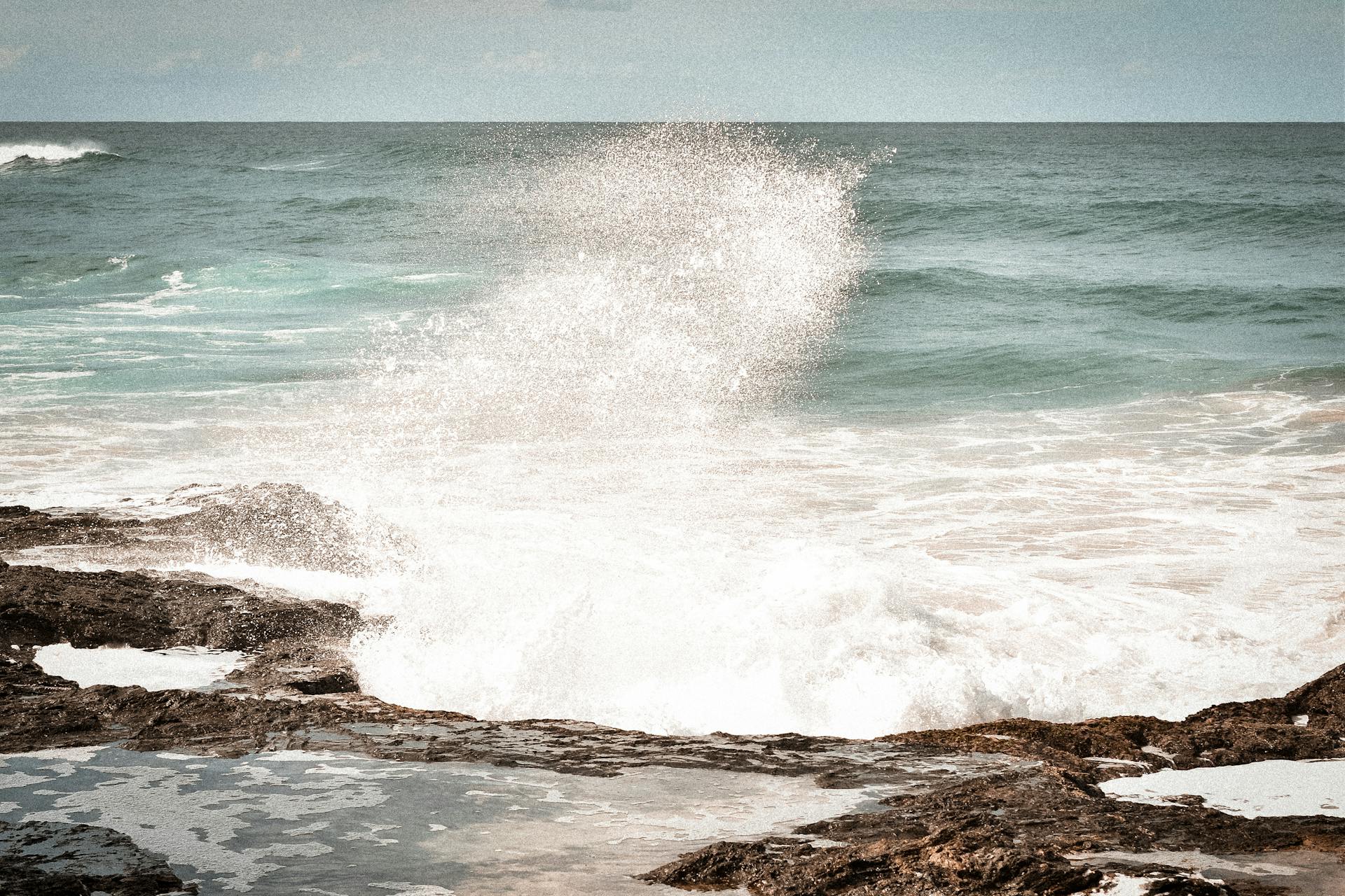 Dynamic ocean waves splashing on rocky shores at Port Macquarie in NSW, Australia.