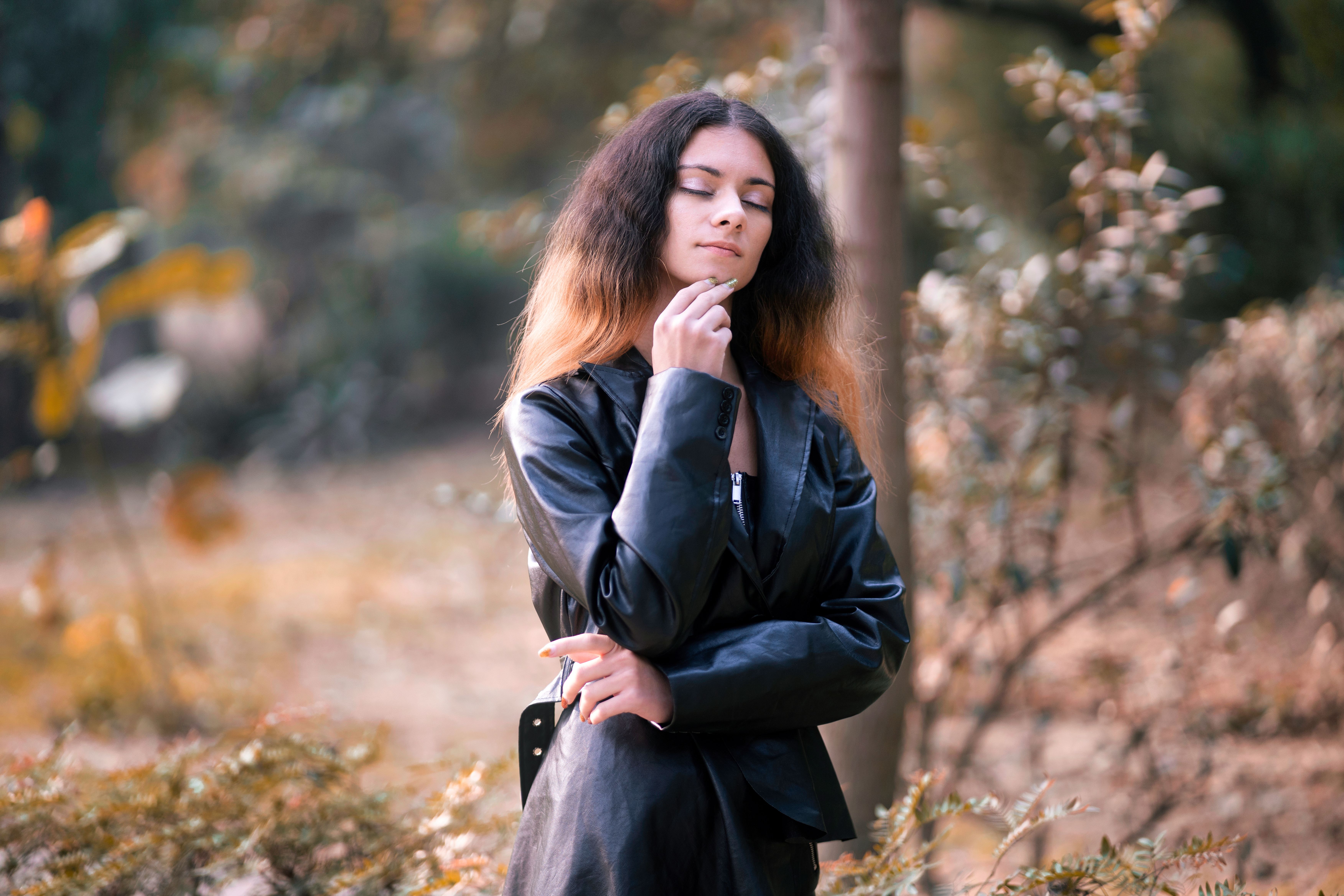 A Woman in a Black Leather Jacket with Eyes Closed · Free Stock Photo