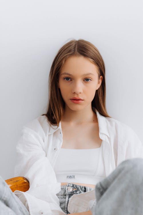 A Teenage Girl Posing on a White Background