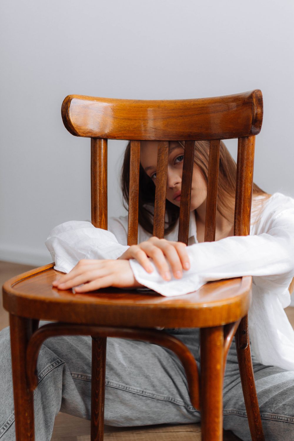 Chair Behind Girl Posing behind Chair · Free Stock Photo