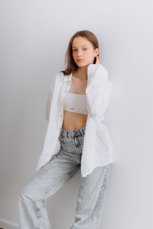 A Teenage Girl in a White Shirt on a White Background