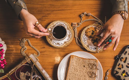 Woman Hands over Cookie and Coffee