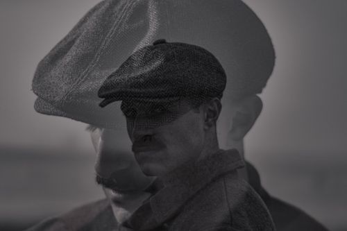 Free Artistic black and white double exposure of a man in a vintage peaked cap. Stock Photo