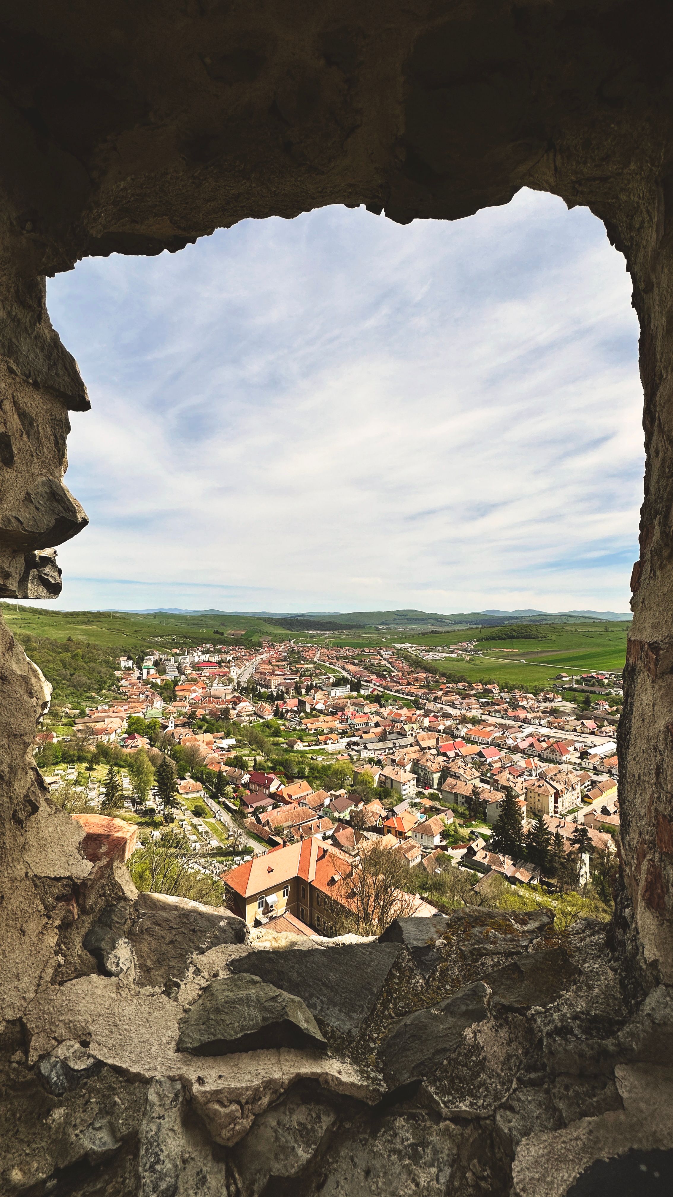 Explore the picturesque town of Rupea, Romania through historic stone ruins.