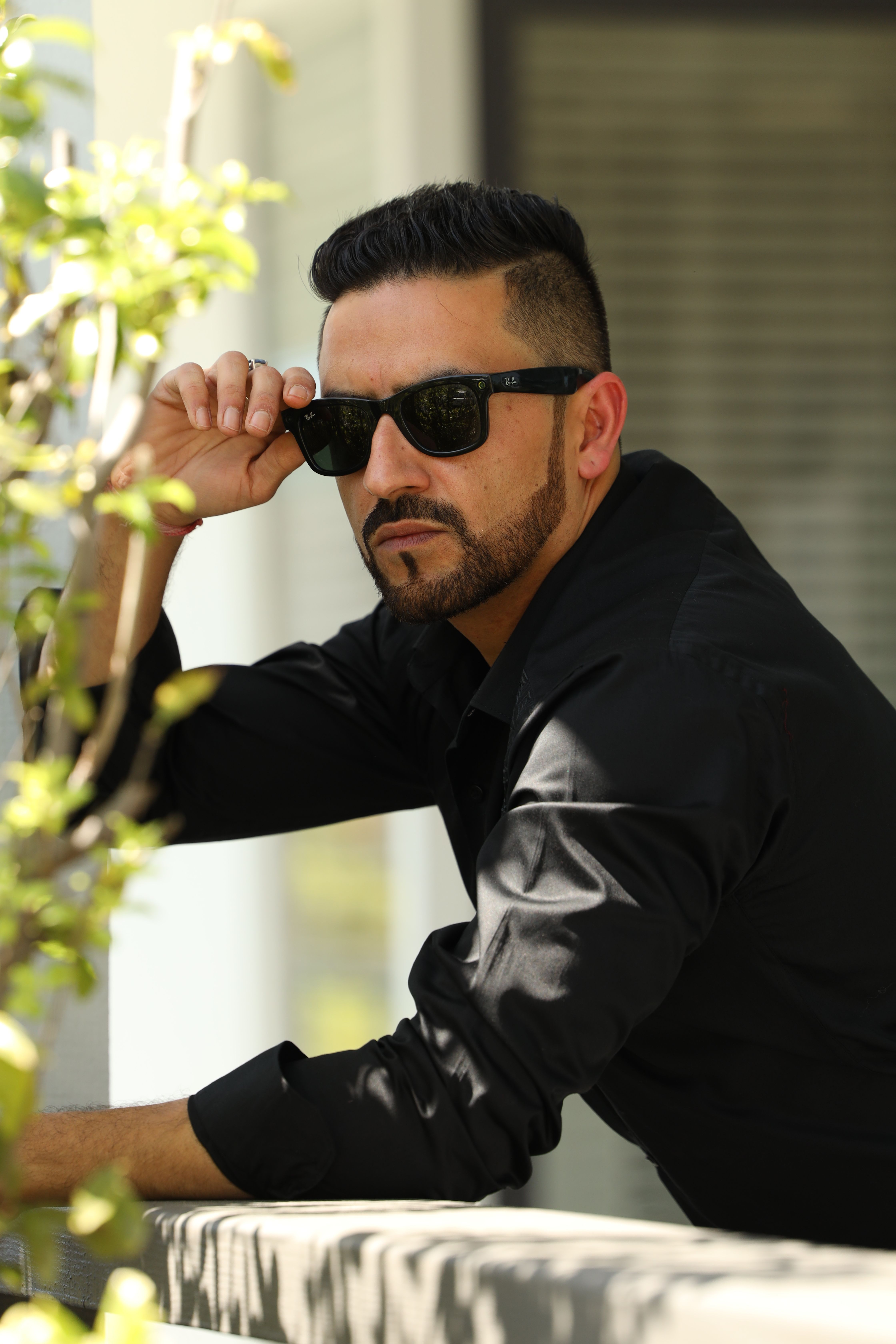 Portrait of a stylish man with sunglasses outdoors in Los Angeles, exuding coolness and confidence.
